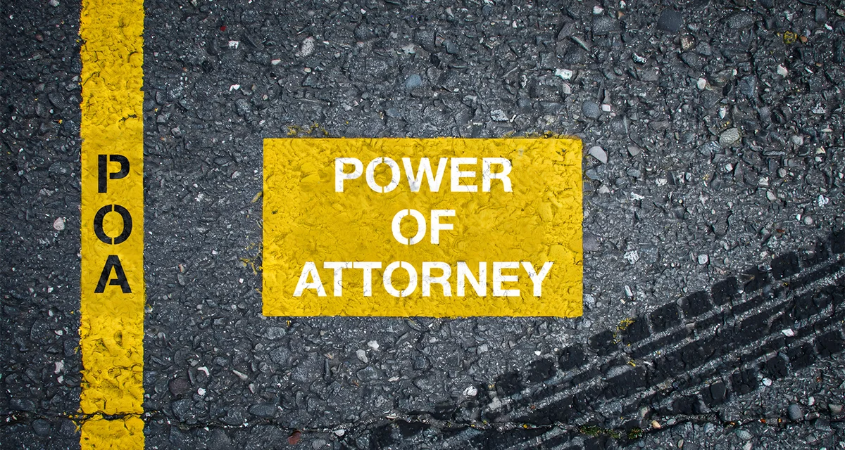 Yellow asphalt road marking with "Power of Attorney" text next to a yellow line labeled "POA", illustrating key considerations for Power of Attorney Dubai Cost.
