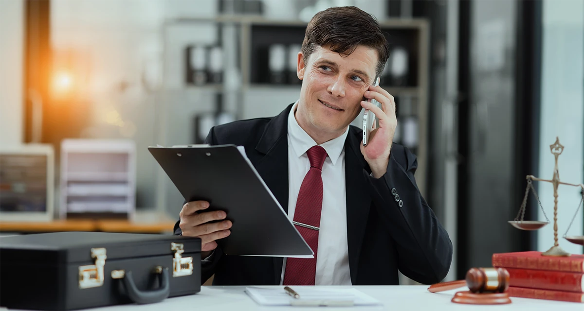 Legal professional in a suit assisting a client with choosing a Power of Attorney service in the UAE.