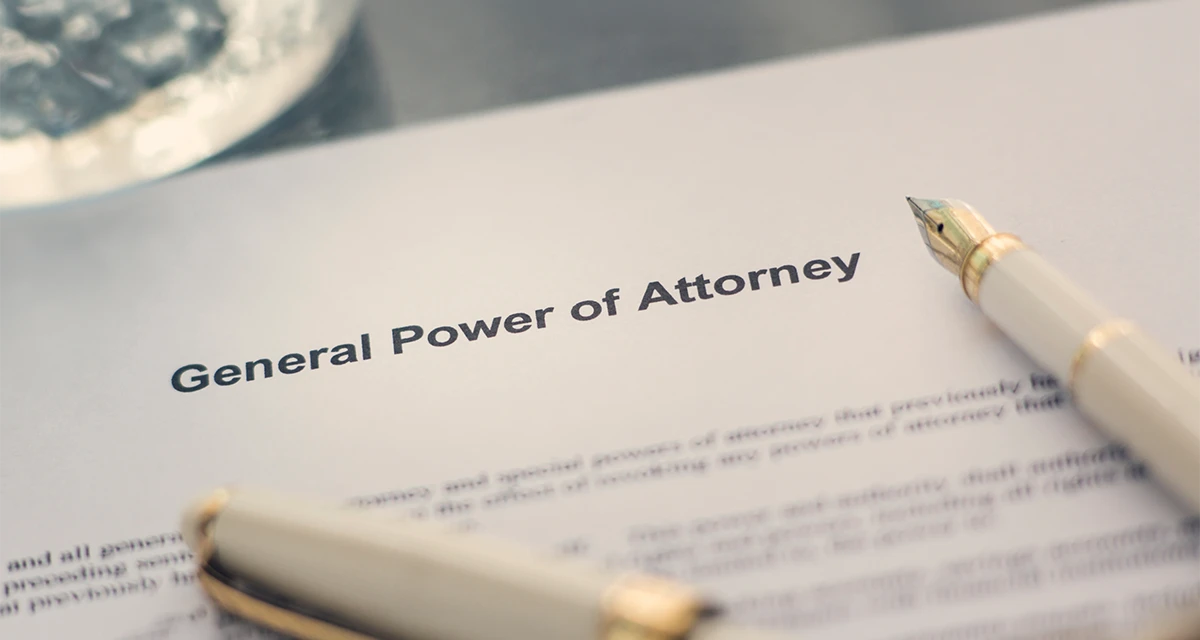 A close-up shot of a legal document titled 'General Power of Attorney' resting on a desk with a fountain pen, representing notary and power of attorney Dubai services.